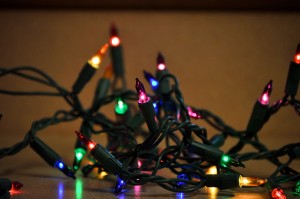 Illuminated string Christmas lights laying on a kitchen counter.